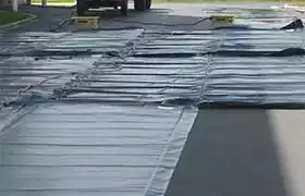 Concrete curing blankets deployed on site